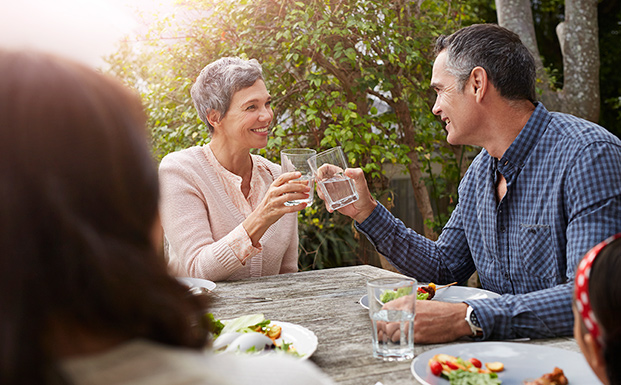 couple-at-table-outdoors-at-dinner-party-supporting-bladder-health