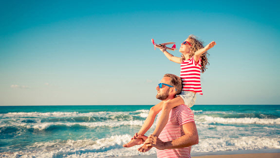 father-with-young-daughter-on-beach-summertime-care-for-children-with-ostomies